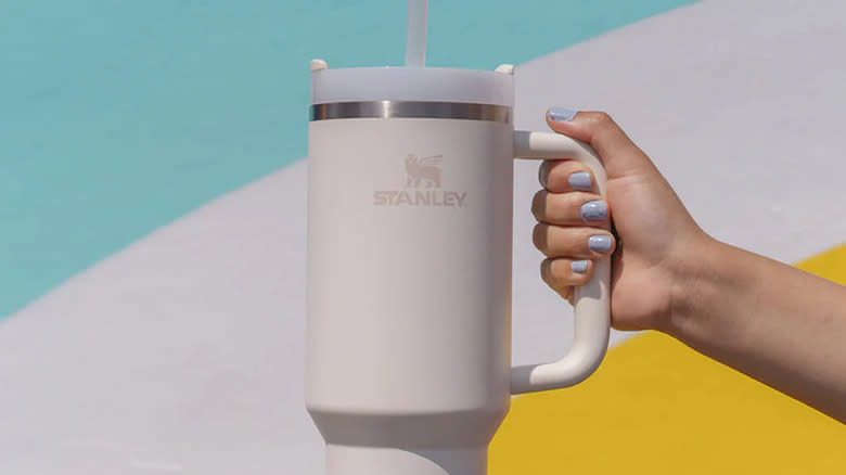 promotional image holding Stanley tumbler