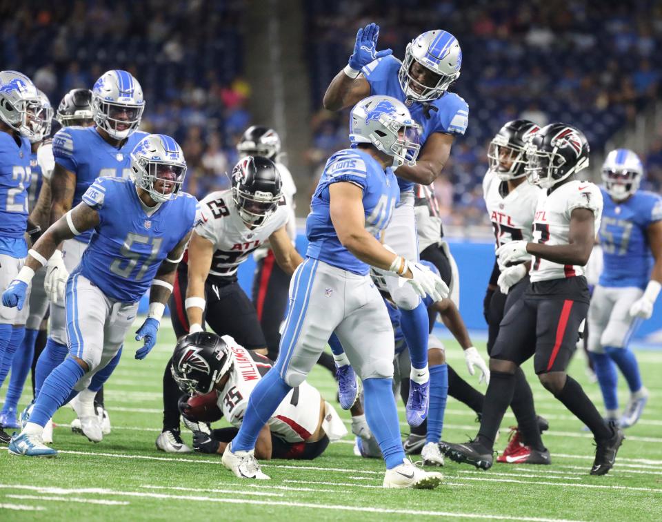 Lions linebacker Malcolm Rodriguez (foreground) celebrates with teammates after a tackle on Atlanta Falcons kick returner Avery Williams (35) during the first half of a preseason game Aug.12, 2022 at Ford Field.