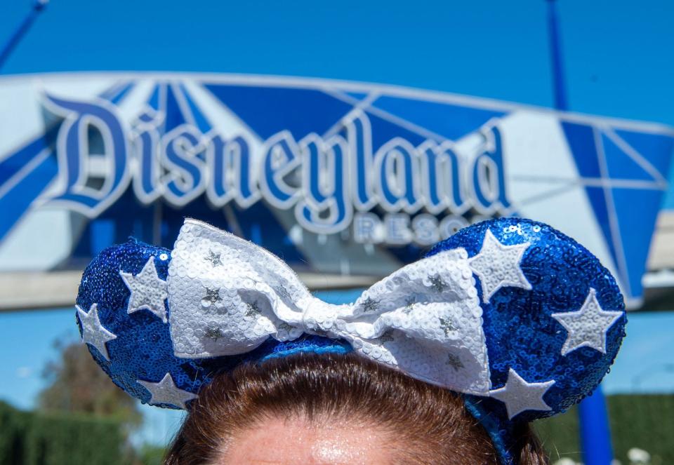 A Disneyland parkgoer wears a Minnie ear headband on April 30, 2021.