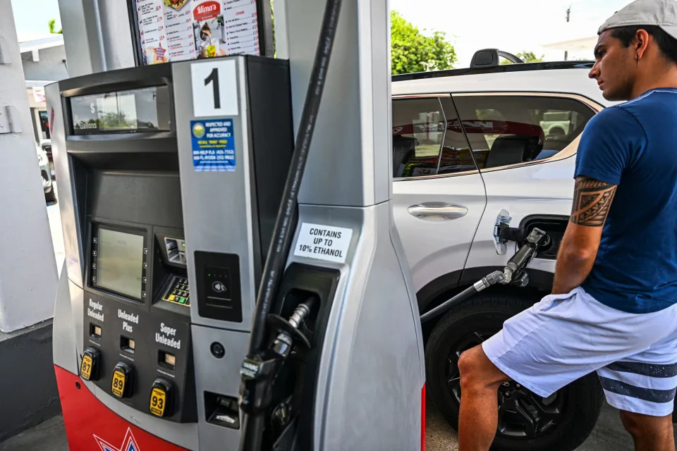 A person pumps gas into his car at a gas station in Miami on July 19, 2022, as U.S. gasoline prices have fallen from historic highs earlier in the summer. (Photo by CHANDAN KHANNA/AFP)