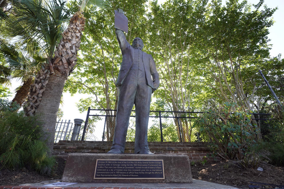 A statue depicts a man holding the state law that made Juneteenth a state holiday in Galveston, Texas. (David J. Phillip/AP)