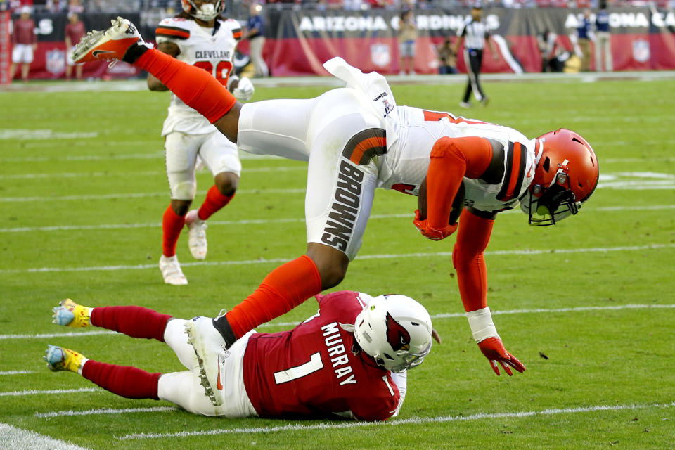 Cleveland Browns linebacker Mack Wilson is tackled by Arizona Cardinals quarterback Kyler Murray (1) after intercepting a pass during the first half of an NFL football game, Sunday, Dec. 15, 2019, in Glendale, Ariz. (AP Photo/Ross D. Franklin)