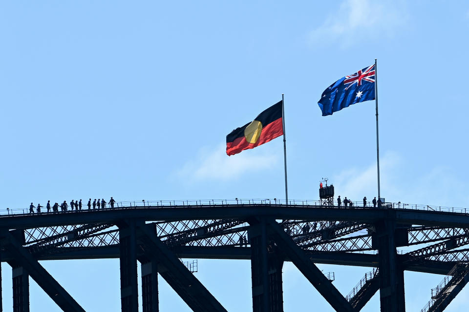 The Aboriginal and Australian national flags are seen on top of the Sydney Harbour Bridge during Australia Day 2022 celebrations, in Sydney, Wednesday, January 26, 2022