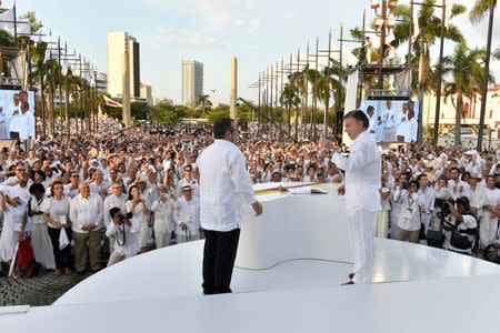 Colombian President Juan Manuel Santos (R) and Marxist rebel leader Rodrigo Londono, better known by the nom de guerre Timochenko, after signing an accord ending a half-century war that killed a quarter of a million people, in Cartagena, Colombia September 26, 2016. Colombian Presidency/Handout via Reuters/File Photo