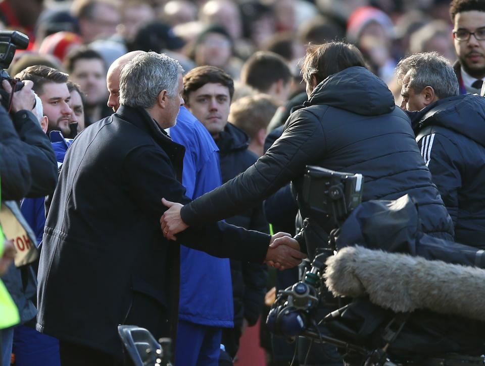 Mourinho (left) and Conte shake hands at Old Trafford
