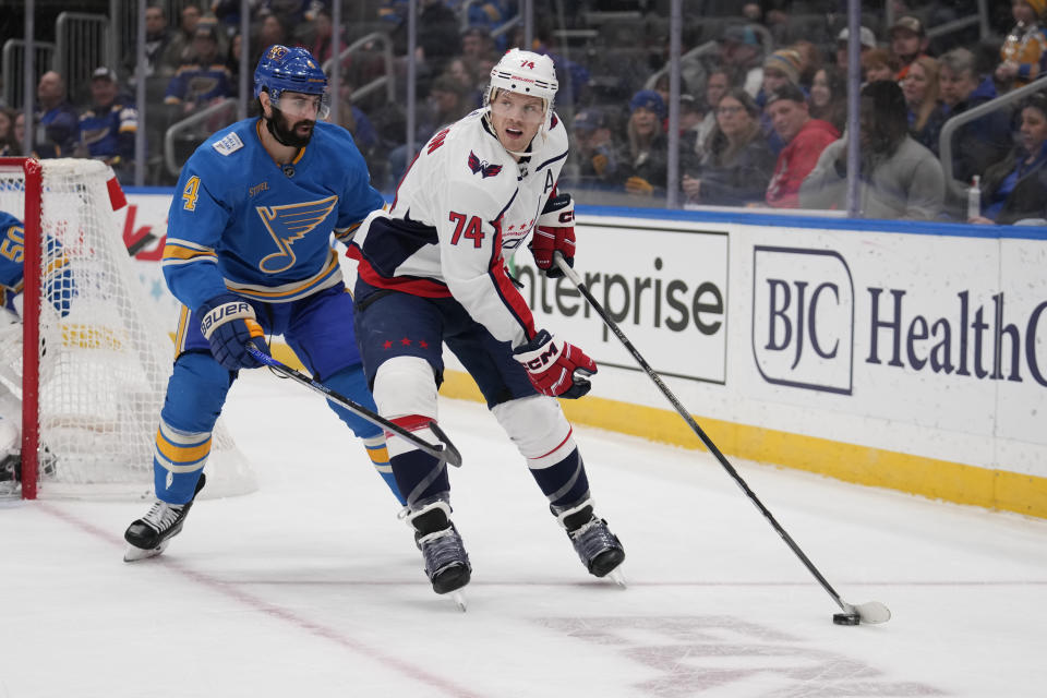 Washington Capitals' John Carlson (74) handles the puck as St. Louis Blues' Nick Leddy (4) defends during the third period of an NHL hockey game Saturday, Jan. 20, 2024, in St. Louis. (AP Photo/Jeff Roberson)