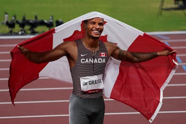 Canada's Andre De Grasse celebrates his gold medal in the men's 200 metres at the Tokyo Olympics. The Canadian is hoping to add more of the same at Paris 2024 with improved starts. (Nathan Denette/The Canadian Press - image credit)