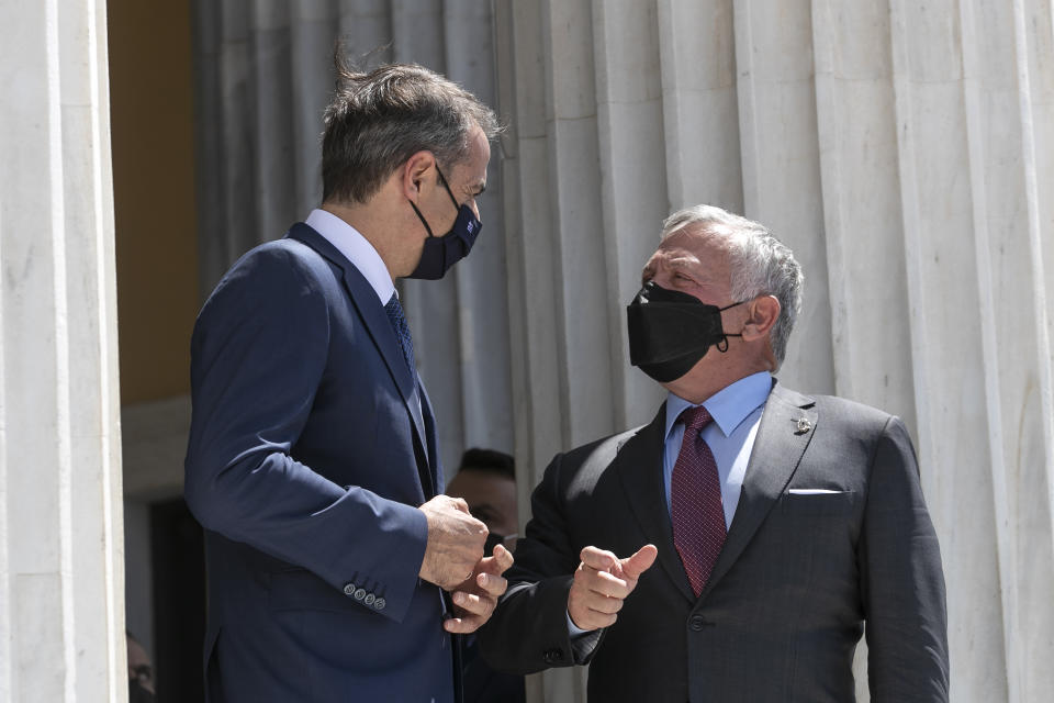 Jordan's King Abdullah II, right, speaks with Greek Prime Minister Kyriakos Mitsotakis ahead of a meeting in Athens, on Wednesday, July 28, 2021. Greece hosts a one-day trilateral meeting of Greece, Jordan and Cyprus. (AP Photo/Yorgos Karahalis)