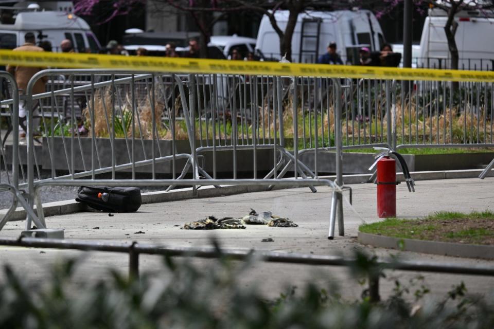 A fire extinguisher remains on the scene outside the park where Azzarello self-immolated on Friday (AFP via Getty Images)