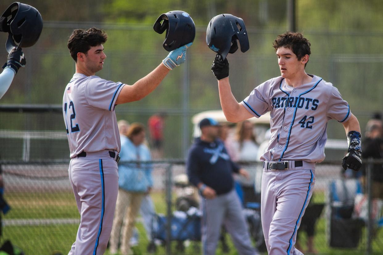 John Jay East Fishkill's Austin Seipp, right, clinks helmets with teammate Marc Cretara after hitting a first-inning home run against Arlington during an April 30, 2024 baseball game.