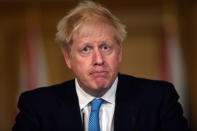 Britain's Prime Minister Boris Johnson speaks to the media in London, Friday, Oct. 16, 2020.Johnson threatened to force Greater Manchester into the most severe level of COVID-19 restrictions after local officials refused to accept the government’s financial package to implement measures targeted at areas with the highest infection rates. (Eddie Mulholland/Pool Photo via AP)