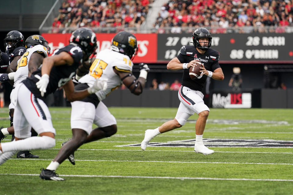 Cincinnati quarterback Ben Bryant runs during the first half of an NCAA college football game against Kennesaw State, Saturday, Sept. 10, 2022, in Cincinnati. (AP Photo/Jeff Dean)