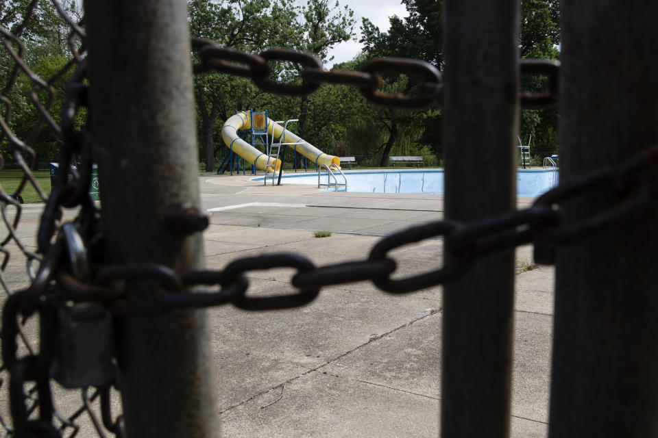 An empty municipal swimming pool is seen at Jordan Park in Allentown, Pa., Friday, May 29, 2020. Left out of the $2 trillion coronavirus relief package passed by Congress in late March, Allentown and thousands of other smaller cities and counties across the U.S. have largely fended for themselves amid sharply falling tax revenues. (AP Photo/Matt Rourke)