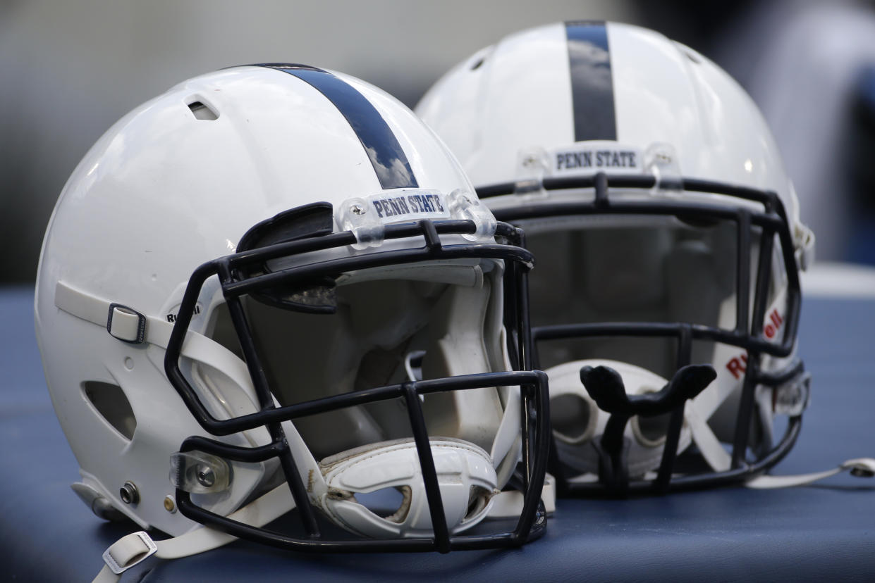 A pair of Penn State football helmets sit on a trainer's table on the sidelines during an NCAA college football game between the Penn State and the Temple in State College, Pa., Saturday, Nov. 15, 2014. (AP Photo/Gene J. Puskar)
