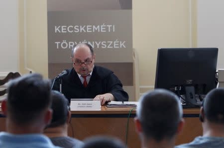 Hungarian judge Janos Jadi speaks, at the start of the trial in which four men are charged with causing the death of 71 migrants who suffocated in a lorry found beside an Austrian motorway in 2015, in Kecskemet, Hungary June 21, 2017. REUTERS/Bernadett Szabo