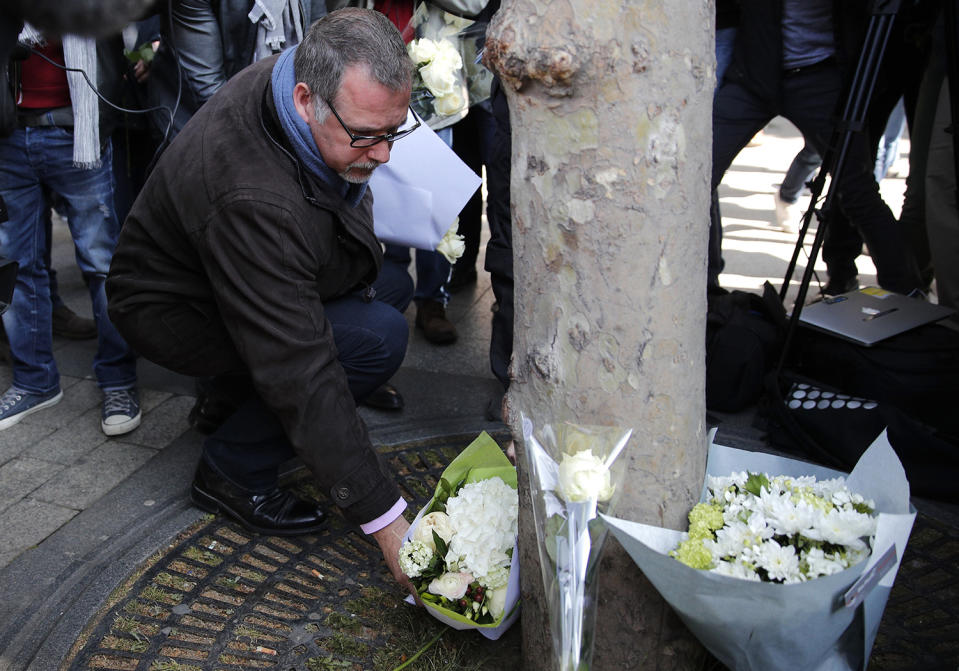 Police union representative places flowers at makeshift memorial