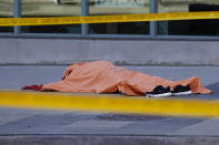 <p>A tarp covers an unidentiified body on Yonge St. at Finch Ave. after a van plowed into pedestrians on April 23, 2018 in Toronto, Ontario, Canada. (Photo: Cole Burston/Getty Images) </p>