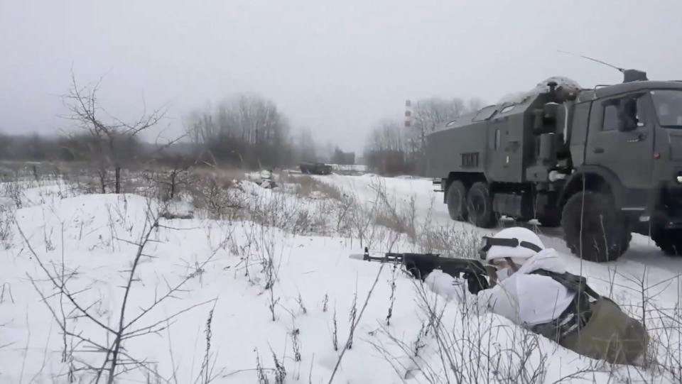 Screenshot of video from Russia's Western Military District showing drills with soldiers, tanks, and missile launchers