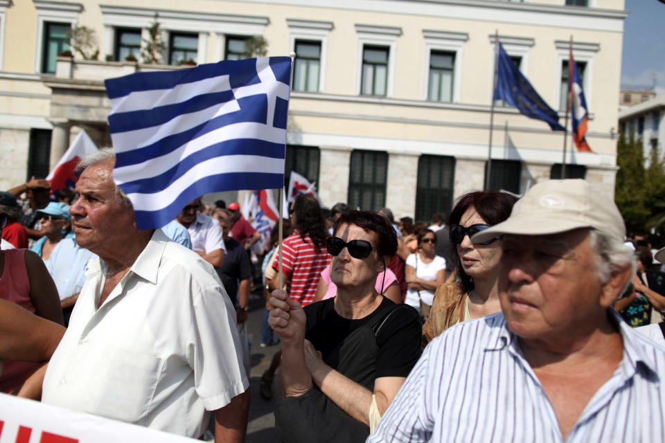 A Pensioners holds a Greek flag during a rally against healthcare cuts, in Athens, on Saturday, Sept. 8, 2012. Greece, in the grip of a severe recession for the fifth straight year, is still struggling to avoid bankruptcy by imposing harsh austerity measures, including wage and pension cuts, with unemployment increasing to nearly a quarter of the workforce.(AP Photo/Petros Giannakouris)