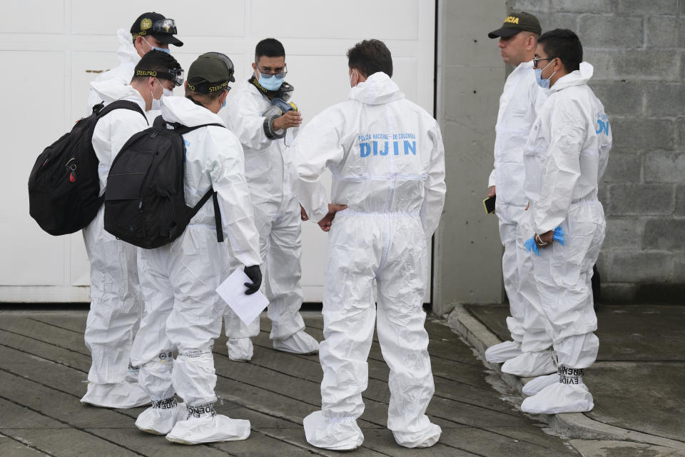 Police investigators prepare to enter a jail where a fatal fire broke out in Tulua, Colombia, Tuesday, June 28, 2022. Authorities say at least 49 people were killed after the broke out inside the prison during what appeared to be an attempted riot early Tuesday. (AP Photo/Juan Jose Horta)