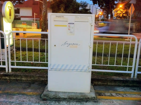 A 48-year-old man dumps faeces into a Singpost mail box. (Yahoo! photo/Ion Danker)