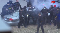 In this image take from video, law enforcement personnel surround a car after it was stopped as the driver approached the crowd near Union Station attending the Super Bowl parade and rally for the Kansas City Chief in Kansas City, Mo., Wednesday, Feb. 5, 2020. (FOXKC via AP)