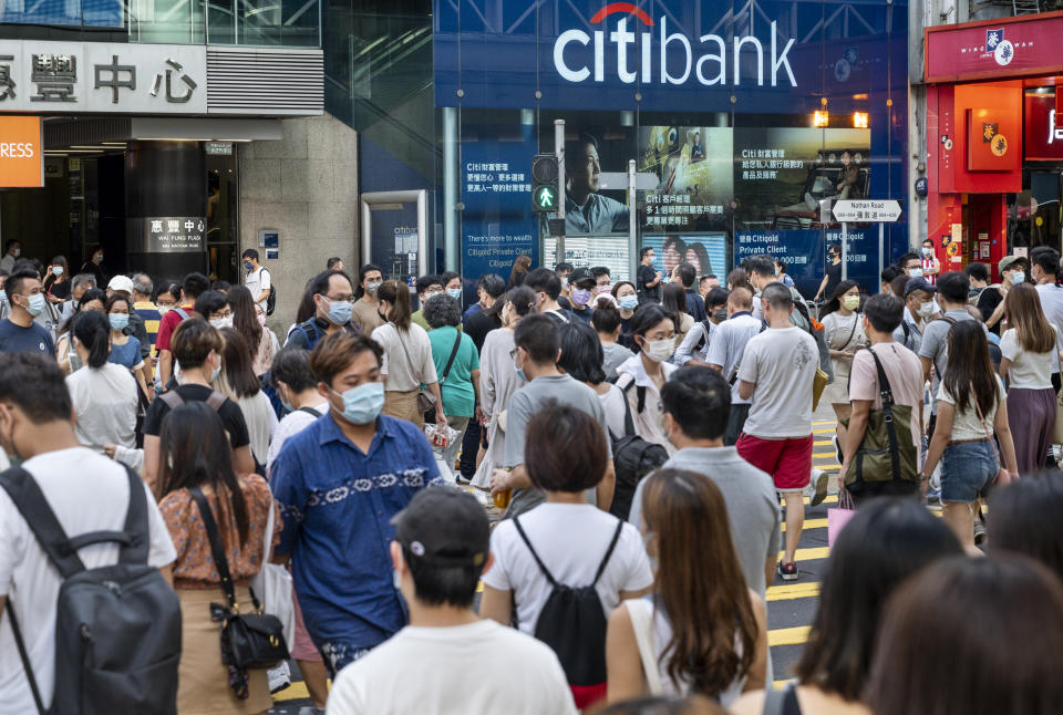 HONG KONG, CHINA - 2022/06/29: Pedestrians wearing face masks cross the street at a traffic light in front of the American multinational investment bank, Citibank or Citi, branch in Hong Kong. (Photo by Budrul Chukrut/SOPA Images/LightRocket via Getty Images)