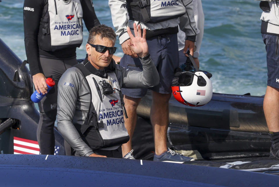 FILE - In this Jan. 30, 2021, file photo, American Magic helmsman, Dean Barker, waves as they return to their team base following their loss to Italy's Luna Rossa in the America's Cup challenger series semifinals on Auckland's Waitemate Harbour, New Zealand. The sting of being the first team eliminated from the 36th America's Cup is going to be with the New York Yacht Club's American Magic for quite some time. American Magic has had a week to ponder the end of its campaign, which was hastened when its yacht, Patriot, capsized and nearly sank during a race in the challenger round-robins on Jan. 17 during a race against Italy's Luna Rose Prada Pirelli Team. (Brett Phibbs/NZ Herald via AP, File)