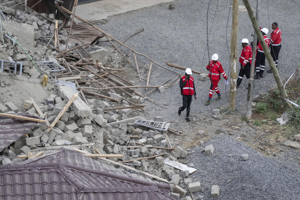 Rescue workers from the Kenya Red Cross attend the scene of a building collapse in the Kasarani neighborhood of Nairobi, Kenya Tuesday, Nov. 15, 2022. Workers at the multi-storey residential building that was under construction are feared trapped in the rubble and rescue operations have begun, but there was no immediate official word on any casualties. (AP Photo/Ben Curtis)