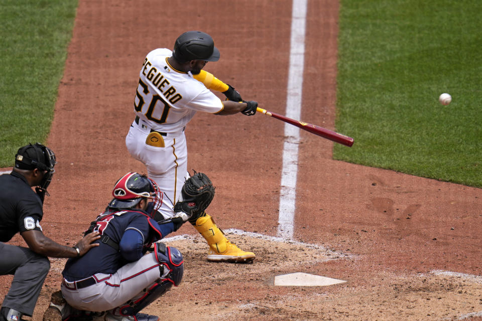 Pittsburgh Pirates' Liover Peguero (60) singles off Atlanta Braves relief pitcher Joe Jimenez, driving in a run, during the sixth inning of a baseball game in Pittsburgh, Thursday, Aug. 10, 2023. (AP Photo/Gene J. Puskar)