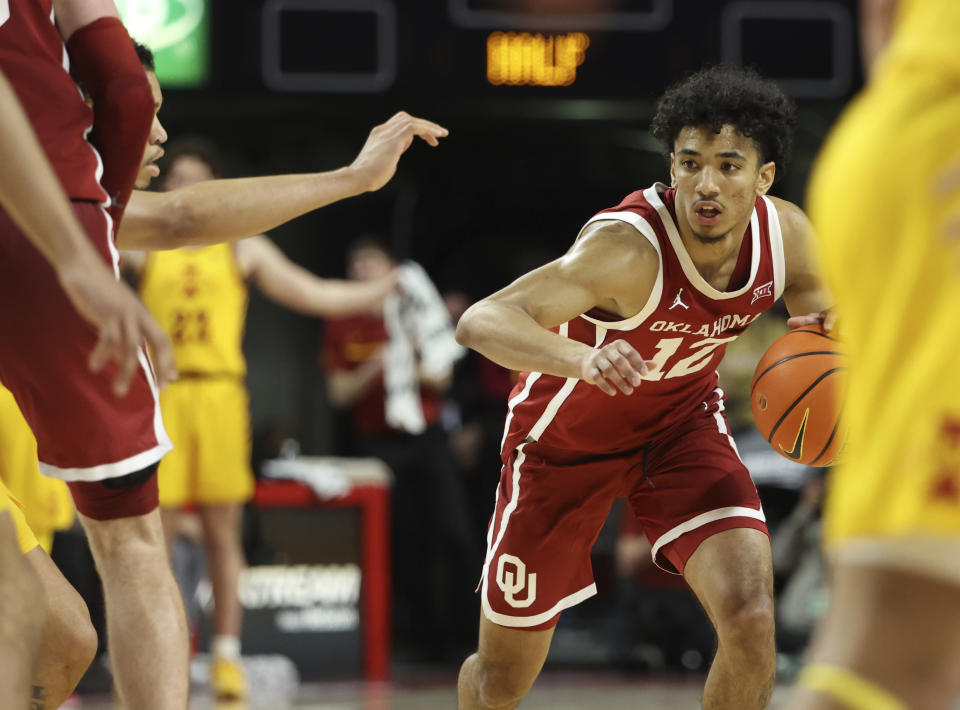 Oklahoma guard Milos Uzan (12) looks for an opening to drive to the hoop during the second half of an NCAA college basketball game against Iowa State, Saturday, Feb. 25, 2023, in Ames, Iowa. (AP Photo/Justin Hayworth)