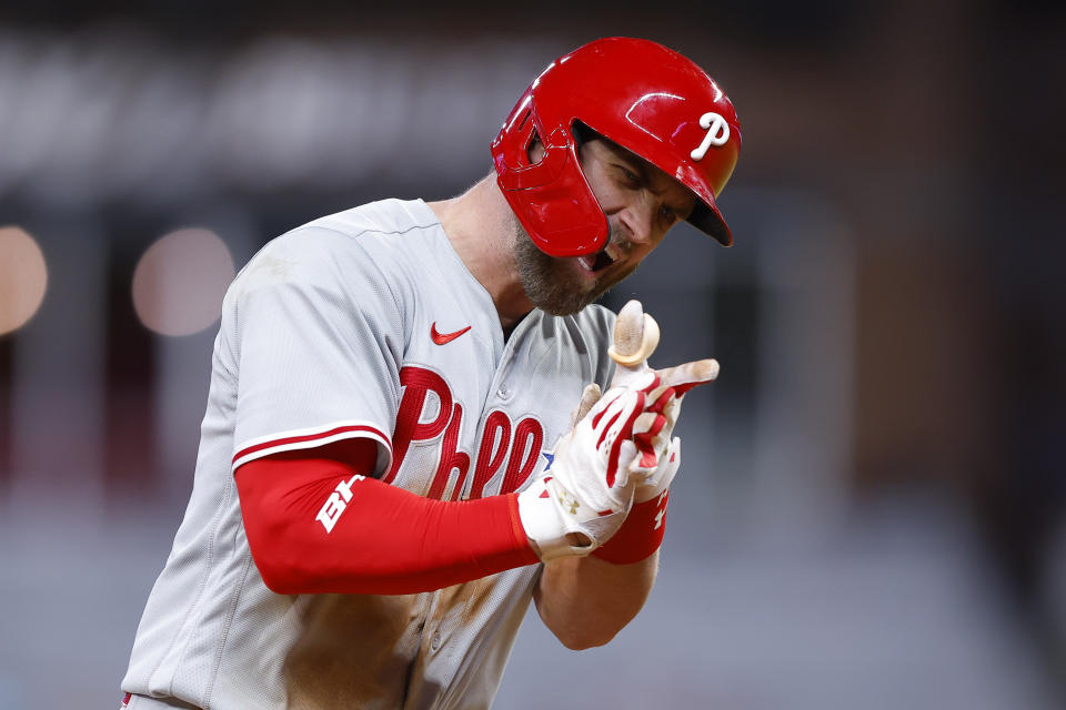 Philadelphia Phillies Bryce Harper reacts after hitting a two run home run in the ninth inning of a baseball game against the Atlanta Braves, Tuesday, May 24, 2022, in Atlanta. (AP Photo/Todd Kirkland)