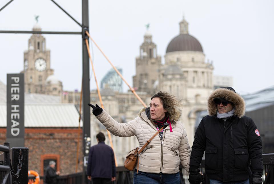 A person's hair is blown in the wind at the Pier Head in Liverpool, Britain, 24 January (EPA)