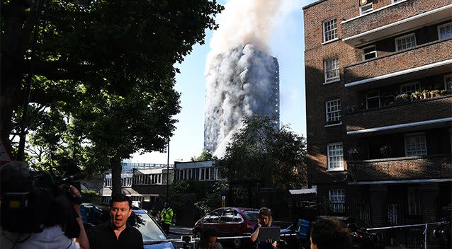 A view of the Grenfell Tower with smoke pouring out. Photo: AAP