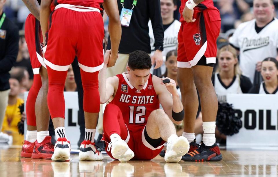 N.C. State’s Michael O’Connell (12) is helped up after being injured during the first half of N.C. State’s game against Purdue in the NCAA Tournament national semifinals at State Farm Stadium in Glendale, Ariz., Saturday, April 6, 2024.