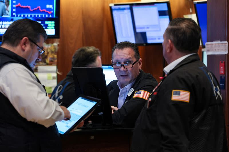 Traders work on the floor of the NYSE in New York