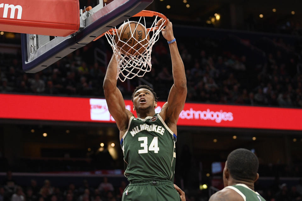 Milwaukee Bucks forward Giannis Antetokounmpo (34) dunks during the first half of an NBA basketball game against the Washington Wizards, Monday, Feb. 24, 2020, in Washington. (AP Photo/Nick Wass)