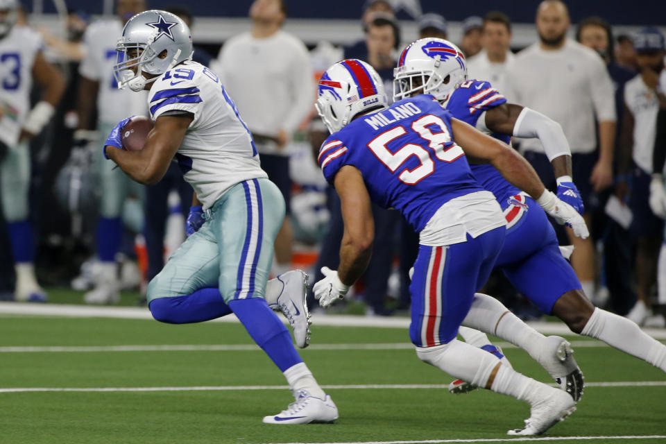 Dallas Cowboys wide receiver Amari Cooper (19) catches a pass for a first down as Buffalo Bills linebacker Matt Milano (58) gives chase in the first half of an NFL football game in Arlington, Texas, Thursday, Nov. 28, 2019. (AP Photo/Michael Ainsworth)