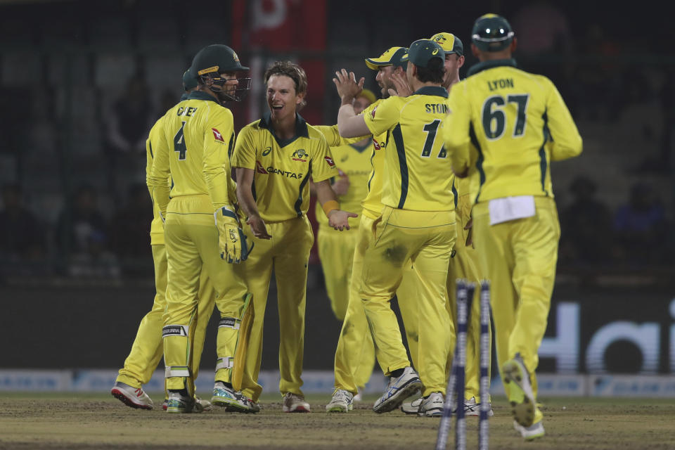 Australian players celebrate the dismissal of India's Rohit Sharma during the final one day international cricket match between India and Australia in New Delhi, India, Wednesday, March 13, 2019. (AP Photo/Altaf Qadri)