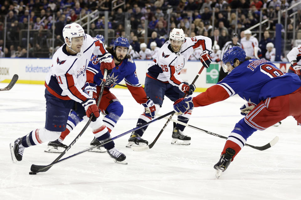 Washington Capitals right wing Garnet Hathaway (21) has his shot blocked by New York Rangers defenseman Jacob Trouba during the first period of an NHL hockey game Tuesday, Dec. 27, 2022, in New York. (AP Photo/Adam Hunger)