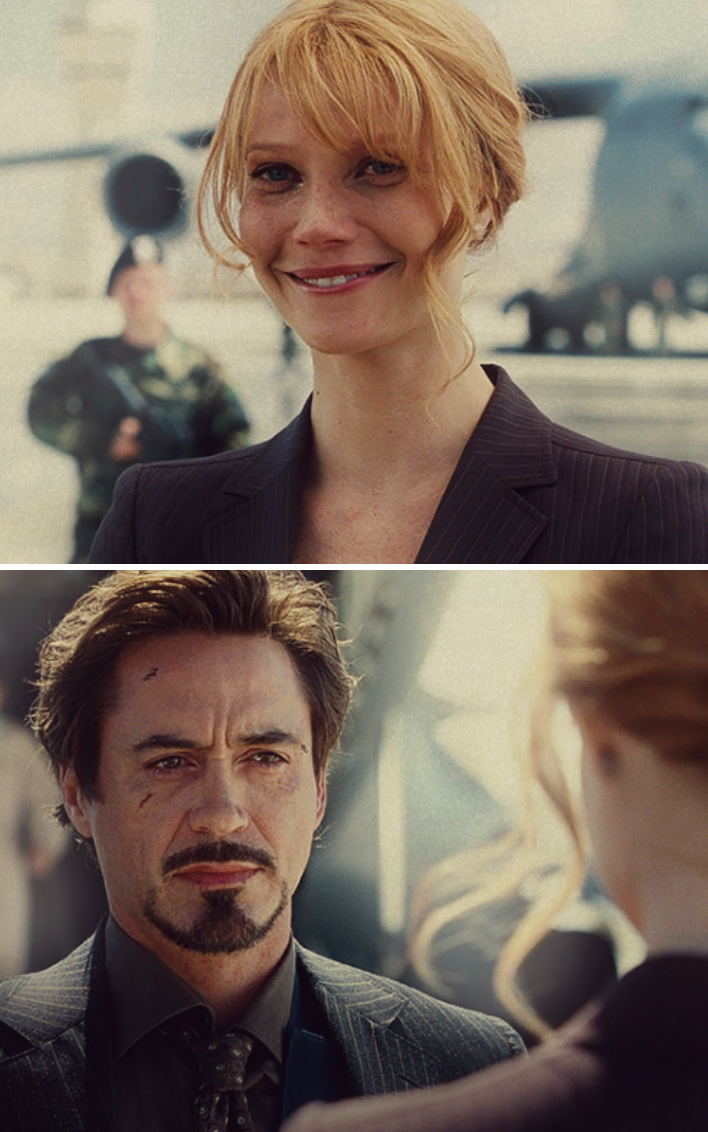 Pepper and Tony looking at each other at the end of "Iron Man" with battle scars on their faces