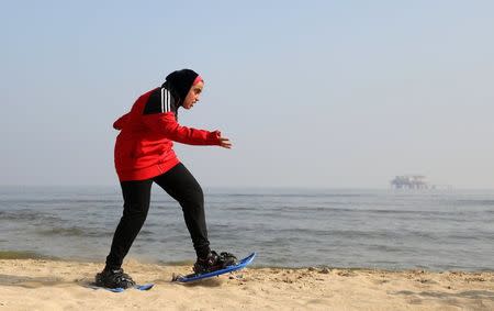 Special Olympics athlete Esraa Gamal trains with snowshoes on a beach in Alexandria, Egypt, July 18, 2017. REUTERS/Mohamed Abd El Ghany
