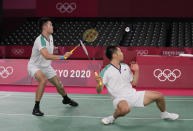 Taiwan's Wang Chi-Lin, left, and Lee Yang compete against China's Li Jun Hui and Liu Yu Chen during their men's doubles gold medal Badminton match at the 2020 Summer Olympics, Saturday, July 31, 2021, in Tokyo, Japan. (AP Photo/Dita Alangkara)