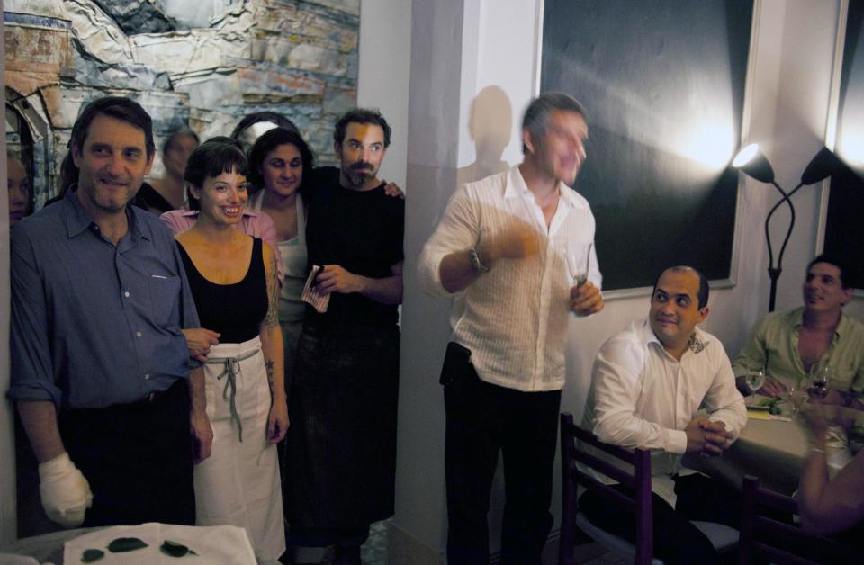 In this Dec. 7, 2012 photo, from left to right, U.S. cooks, Jerome Waag, Melissa Hernandez, Samin Nosrat and Charlie Hallowell look out toward the dinning area after preparing a meal at the private restaurant Le Chansonnier in Havana, Cuba. The U.S. chefs visited Cuba as part of the "Planting Seeds" delegation that held give-and-take seminars with chefs and culinary students about slow food. Their advice to Cuban cooks who struggle with unreliable supply of even basic ingredients like eggs: Be flexible, and don't worry too much about maintaining a fixed menu. (AP Photo/Ramon Espinosa)