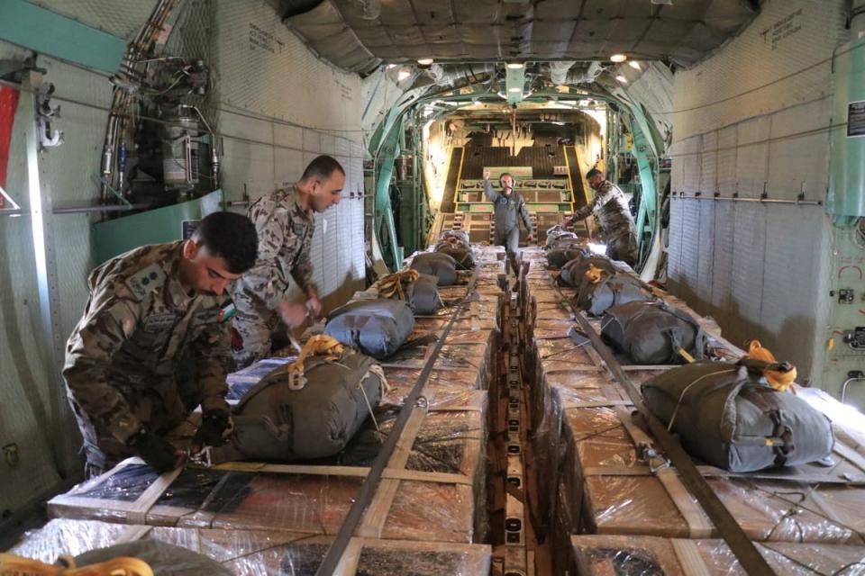 Members of the Jordanian armed forces prepare to drop aid parcels to several areas in northern Gaza (via Reuters)