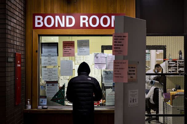 PHOTO: A man pays cash bail in the bond office to secure his brother's release on Dec. 21, 2022 at Division 5 of Cook County Jail in Chicago. The elimination of cash bail is among the criminal justice reforms in the SAFE-T Act. (Chicago Tribune/TNS via Getty Images)