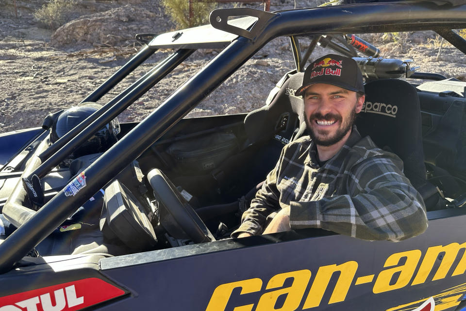 AJ Jones, the youngest driver and only American to win the Dakar Rally twice, poses on Nov. 27, 2023, in Congress, Ariz.. He also has won the Baja 1000 twice. Jones followed the footsteps of his father, Jesse, an accomplished rally car racer after playing lacrosse on scholarship at San Diego State. (AP Photo/John Marshall)