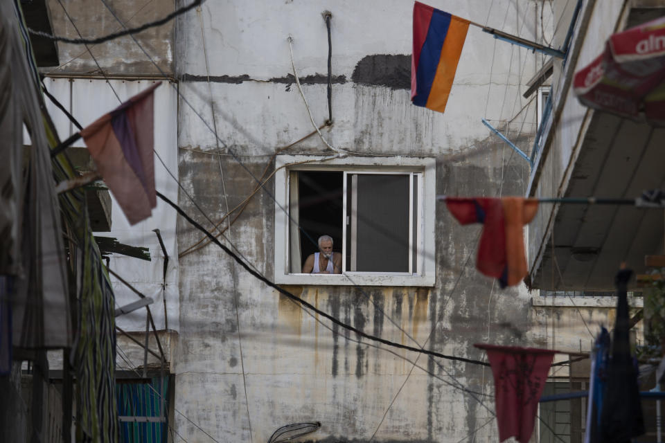 Armenian national flags hang from apartment balconies in the main Armenian district of the northern Beirut suburb of Bourj Hammoud, Lebanon, Tuesday, Oct. 6, 2020. In Bourj Hammoud anger and anxiety are clear among the population over the fighting between Armenian and Azerbaijani forces in the separatist region of Nagorno-Karabakh that broke out on Sept. 27 and has left dozens killed since then. Hundreds of fighters from around the Middle East are heading to Nagorno-Karabakh in Azerbaijan to join rival countries fighting over the region. (AP Photo/Hassan Ammar)