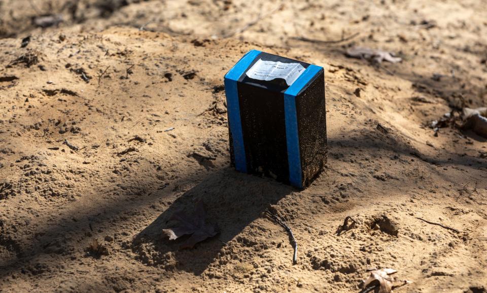 A box with a label from the Tri-County Cremation Services sits on top of a dirt hill inside the Oak Grove Burying Ground in Taylor on Wednesday, April 12, 2023. 