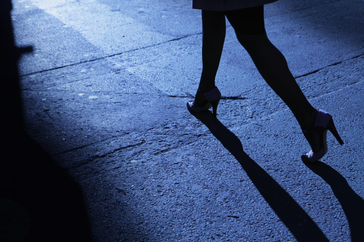 A woman is seen walking at night. (Getty)